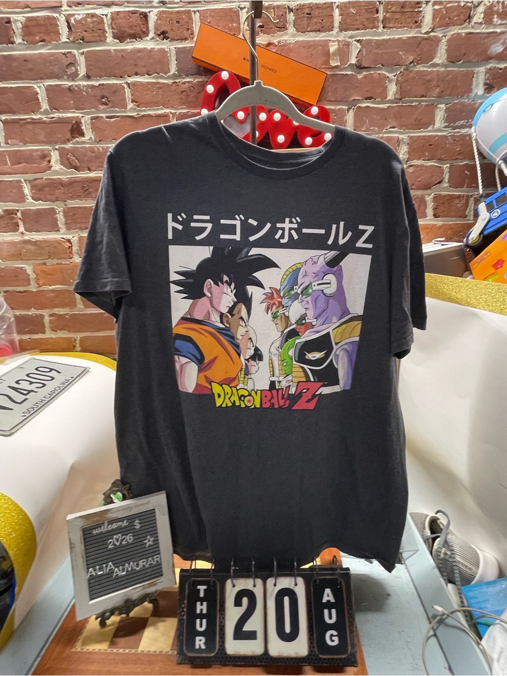 Dragon Ball Z T-Shirt features a classic graphic of Goku, Gohan, and Vegeta